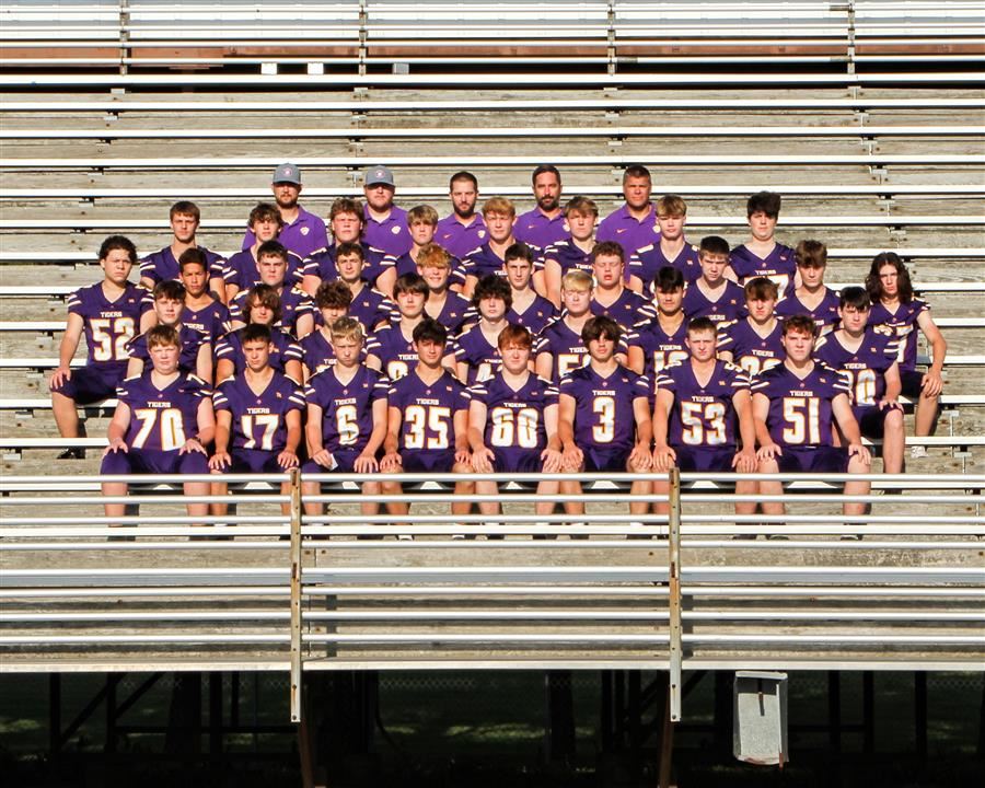 Football players sitting on bleachers