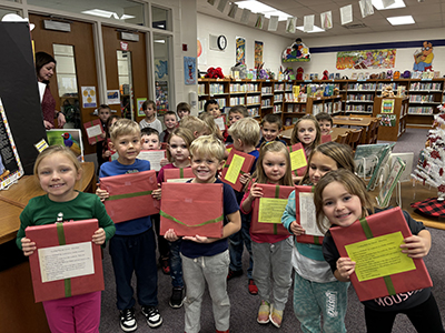  photo of students with wrapped cookbooks